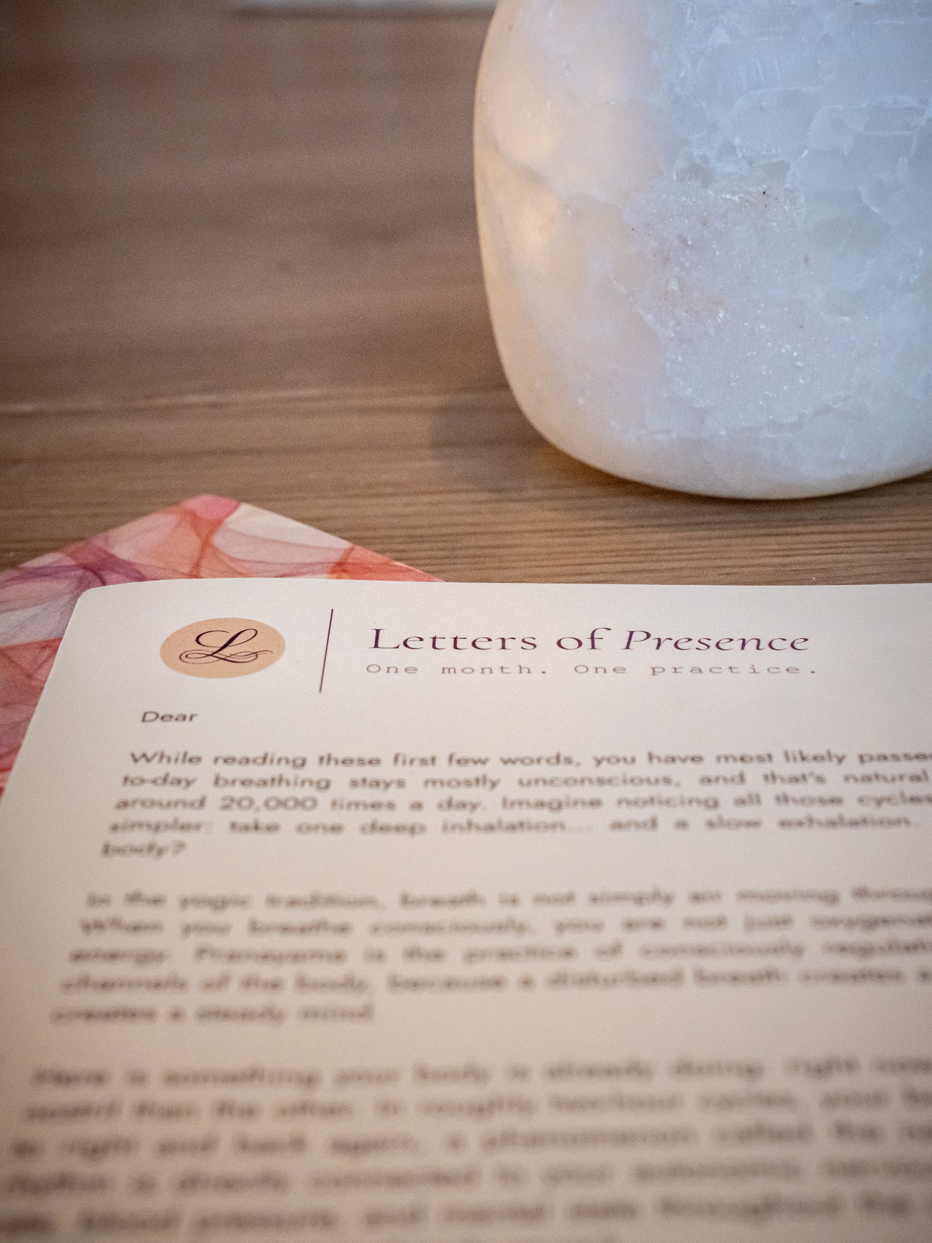 A Letters of Presence letter resting on a table beside a salt lamp